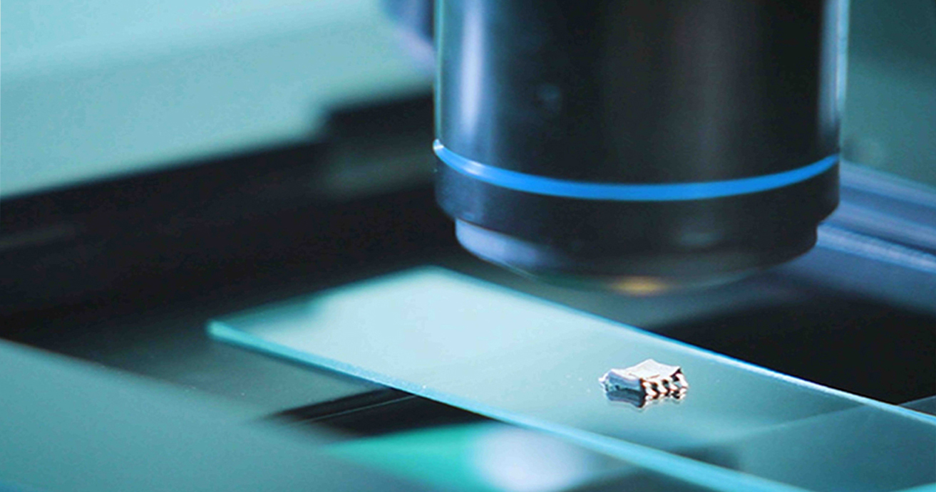 growatt reliability, reliability checking, strict engineering, quality control, Microscope focused on a small electronic component on a slide.